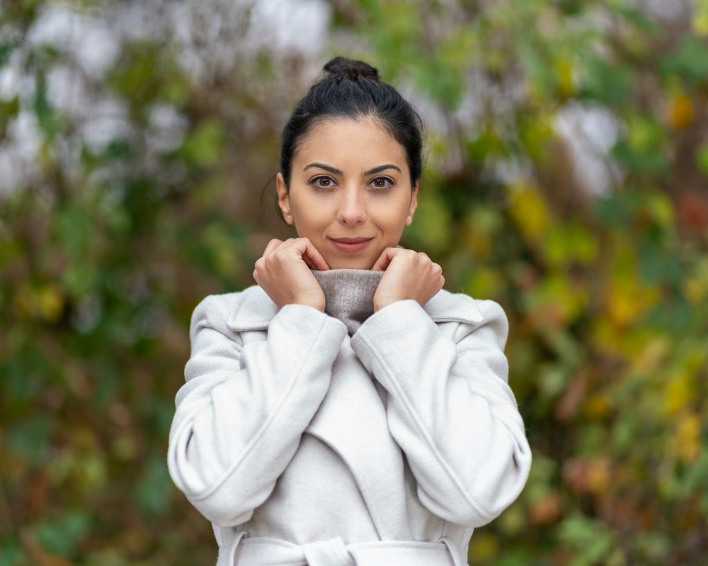 a woman in a bathrobe holding a cup of coffee